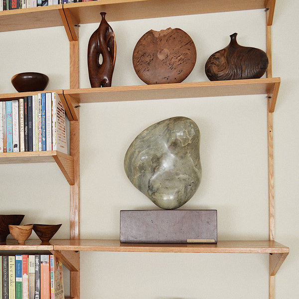 Bob Womack bud vase in display with other wood vessels on bookcase