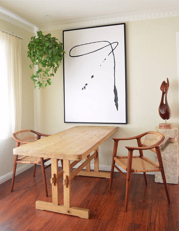 large minimalist abstract painting with trestle table and bambi chairs