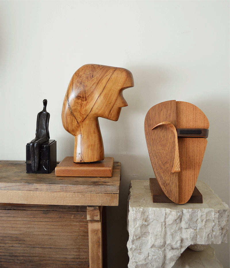 collection of vintage sculptures featuring abstract faces and figures