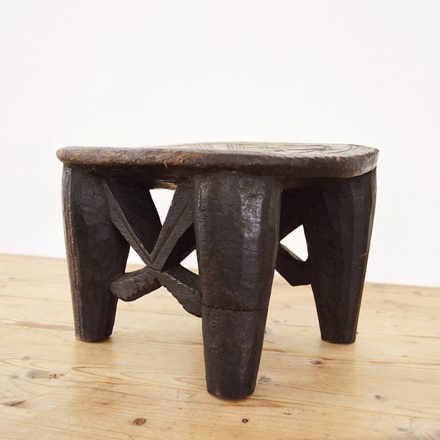 Hand carved solid wood African Nupe stool angled view