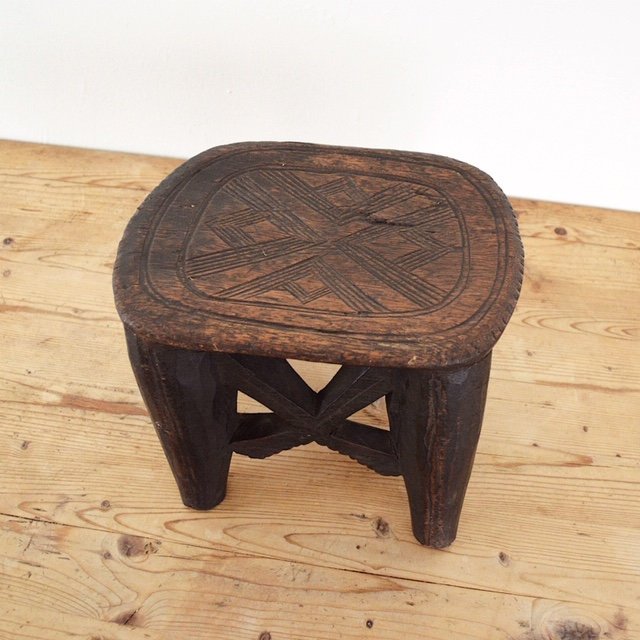 Hand carved solid wood African Nupe stool top view of seat carving