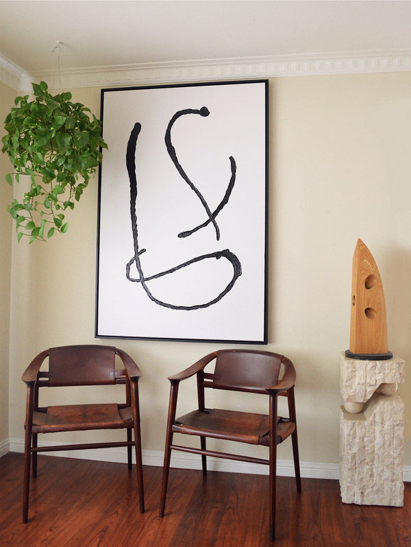 large minimalist abstract painting with leather bambi chairs